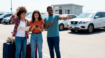Confused travelers with luggage and a map in a parking lot, avoiding common car hire mistakes.