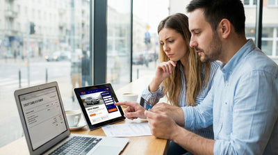 Couple checking credit card statements online to prepare for a car hire deposit.