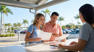 A convertible car rental driving down a sunny, palm-lined coastal highway in Florida
