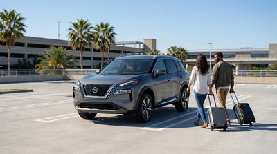 A traveler with a suitcase at a car rental counter inside the Orlando International Airport terminal
