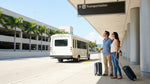 Travelers with suitcases waiting in line at a car hire counter inside the Miami airport terminal