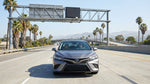 A driver's view from a car hire on a Los Angeles freeway approaching an electronic toll sign