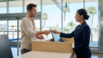 Customer handing a credit card to an agent at a car rental desk in California