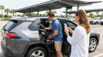 A person photographs the back seat of their family car rental in an Orlando airport parking garage
