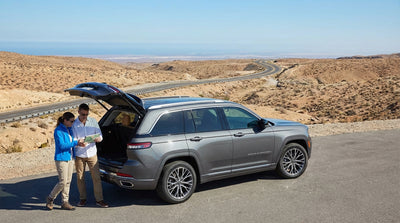A red convertible car hire driving on a desert highway with the Las Vegas skyline in the distance