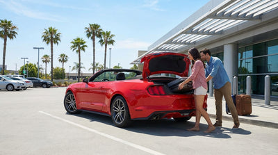 A convertible car hire driving along the scenic Pacific Coast Highway in California