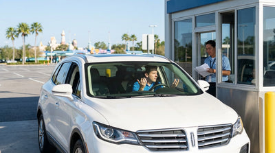 A silver car hire vehicle parked in a vast, sunny theme park parking lot in Orlando