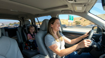 A modern car hire driving on a sunny California freeway with a clear sign for the HOV lane