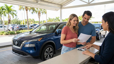 A silver car hire drives down a scenic road lined with palm trees in sunny Florida