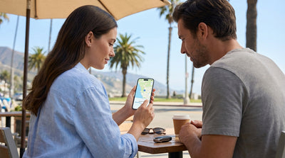 A person holding a phone with a map in a car rental overlooking the sunny California coast