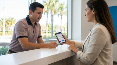 A person driving a convertible car rental down a scenic, palm-lined coastal highway in Florida