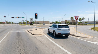 A car hire at a Texas intersection waits at a red light before entering the right-turn slip lane