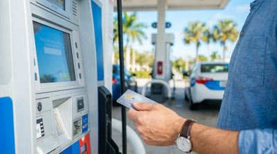 A person refuelling their car hire at a sunny petrol pump in Florida