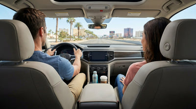 A car hire driving down the Las Vegas Strip at night with the bright, colorful neon lights of the casinos lighting the way