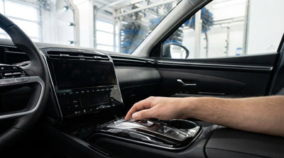 Driver's hand shifting a car hire into neutral with an electronic gear selector in the United States