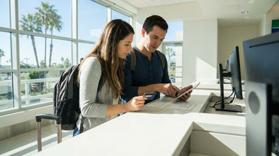 A silver sedan car rental parked along the scenic coast of Big Sur, California at sunset