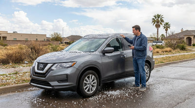 Dark storm clouds gather over a car hire vehicle on a lone highway in the Texas countryside