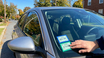 Official Pennsylvania inspection and emissions stickers on the windscreen of a modern car hire vehicle