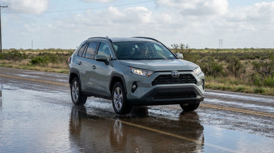 A red car hire stalled in deep floodwater on a Texas street during a thunderstorm