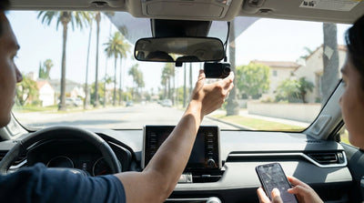 A dash cam films a sunny California highway from the dashboard of a car rental