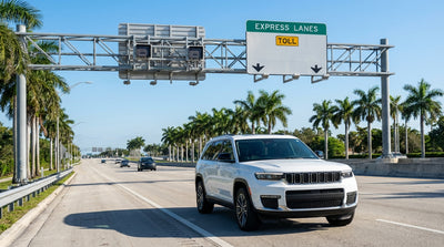 A car rental drives on a sunny highway in Miami with large overhead express lane signs