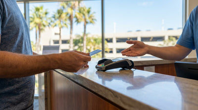 A red convertible car hire driving along the scenic Pacific Coast Highway in California