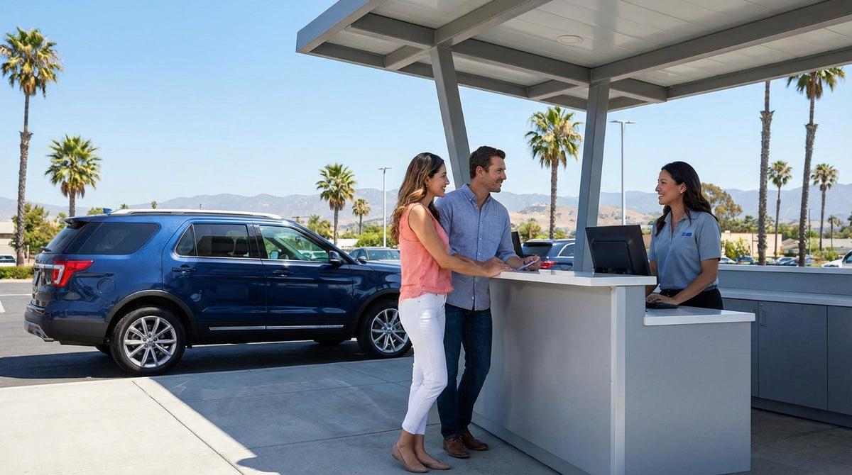 A red convertible car rental driving on a scenic coastal highway in California next to the ocean at sunset