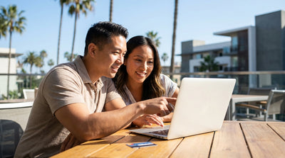A couple drives a red convertible car hire along the sunny Pacific Coast Highway in California