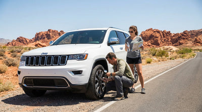 A car hire drives down a scenic road through the vibrant red rock formations of Valley of Fire near Las Vegas