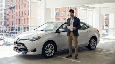 A modern car hire vehicle driving over a bridge towards the iconic New York City skyline