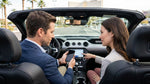 Hand connecting a smartphone to the dashboard touchscreen of a car rental in Las Vegas