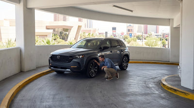 A modern car hire stopped on a steep concrete ramp inside a brightly lit Las Vegas casino car park