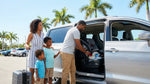 Child safety seat securely installed in the back seat of a car rental parked under sunny Florida palm trees
