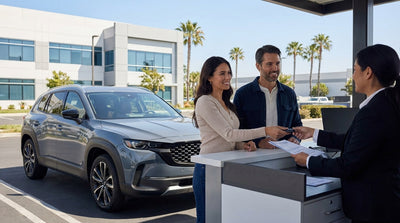 A red convertible car hire driving along the scenic coastal highway in California