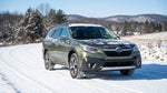 A car rental SUV drives down a snow-covered forest road in the Pennsylvania mountains
