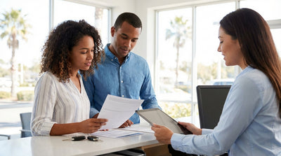 A red convertible car hire driving along a sunny coastal highway in Florida lined with palm trees