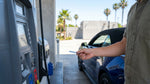 Close up of a person pumping gas into a car rental at a Los Angeles gas station