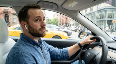 View from a car hire driving down a busy New York City street with yellow cabs and tall buildings