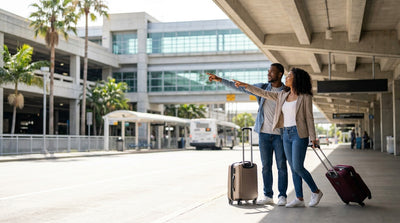 Travelers with luggage boarding a car hire shuttle outside the Tom Bradley Terminal in Los Angeles