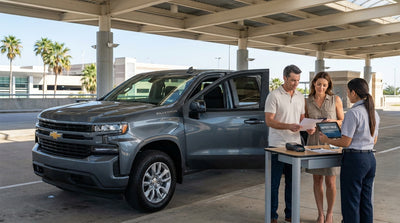 A modern car rental parked on the side of a long, open highway stretching through the plains of Texas