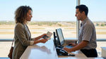 Traveler handing a passport to an agent at a car rental desk in Texas