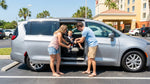 A parent fastening a child seat inside a car rental in sunny Orlando
