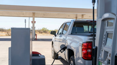 A modern car hire driving on a wide open highway with a big Texas sky overhead