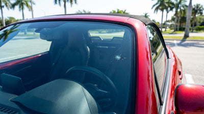 A modern white car hire driving on a scenic coastal highway with palm trees in sunny Florida