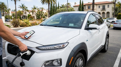 A sleek electric car rental connected to a charging station on a sunny day in Los Angeles