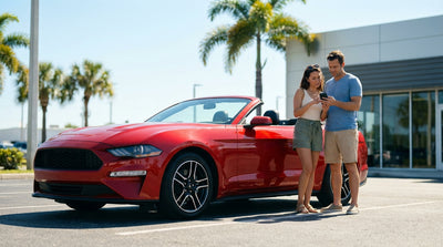 A person driving a convertible car hire down a scenic, palm-tree-lined highway in Florida