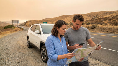 A car rental on a California highway with hazy orange skies from a distant wildfire on the horizon