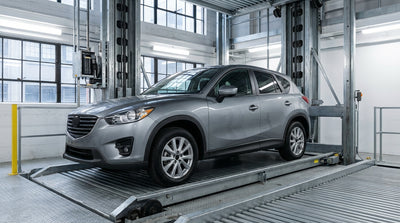 A car rental being moved by an automated lift inside a modern San Francisco garage