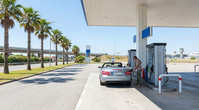 A modern car rental being refueled at a sunny petrol station with palm trees in Miami