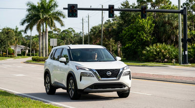 A car hire approaches a busy Florida intersection with palm trees where all the traffic lights are out